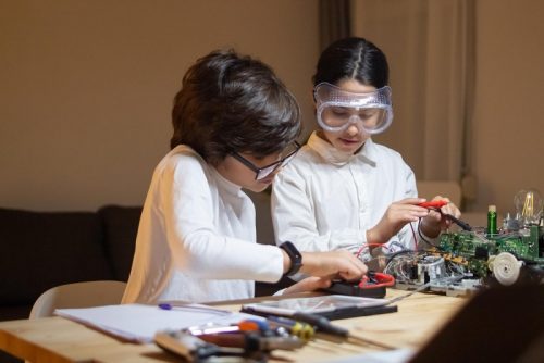 focused-children-doing-experiment-physics-together